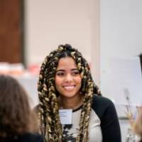 Girls of Color Summit previous event with a girl smiling and listening